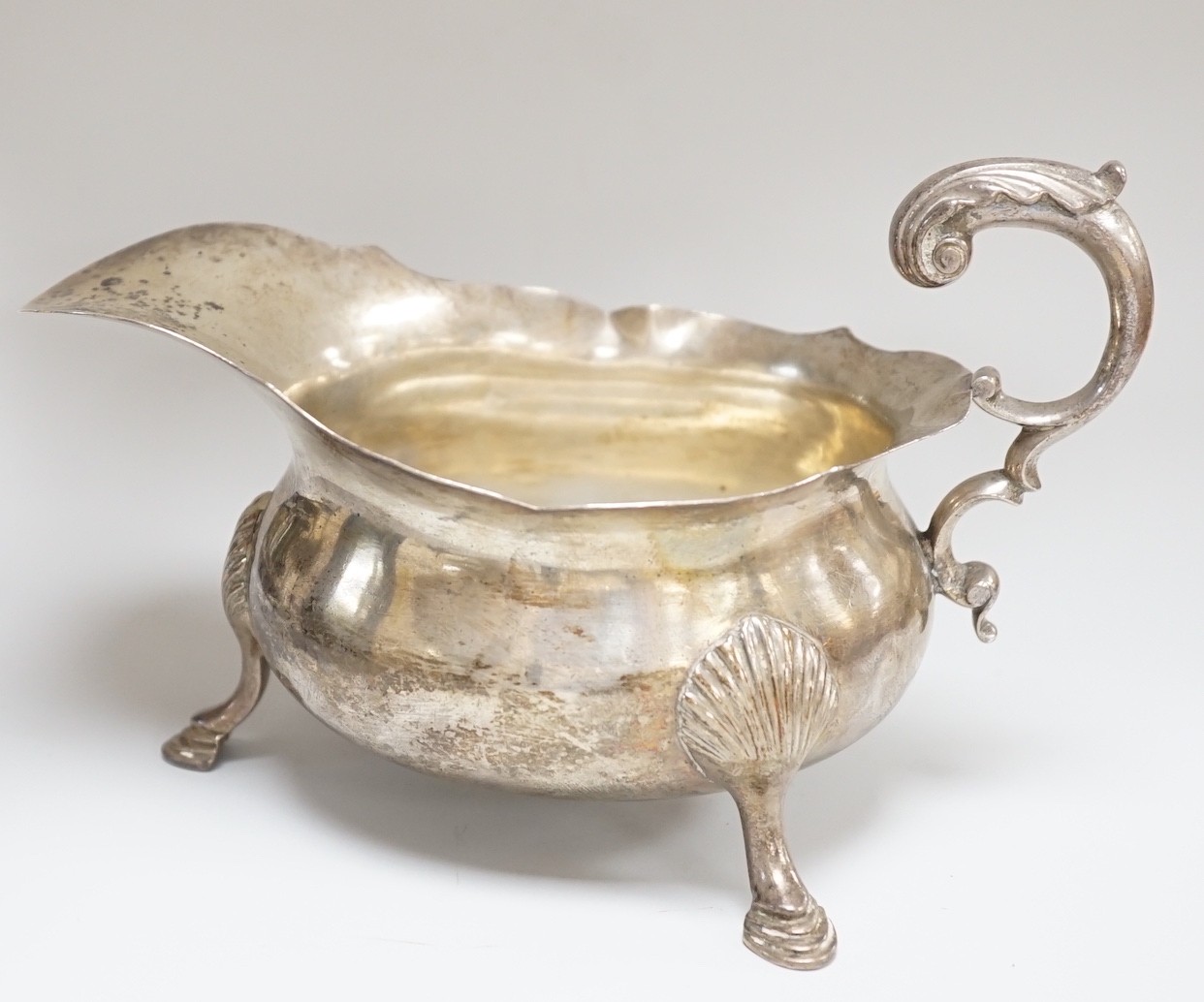 A William IV silver sauceboat, with flying scroll handle, Michael Starkey, London, 1831, length 17.8cm, 8.6oz.